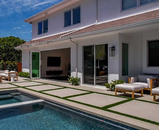 Modern home with bi fold doors opening to a bright outdoor patio for bi fold doors Newport Beach CA.