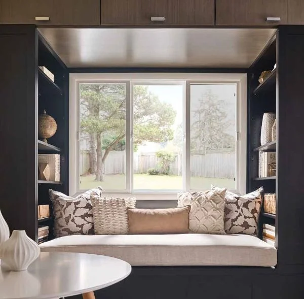 Built-in window seat with backyard view featuring energy efficient Rancho Santa Margarita CA replacement windows. 