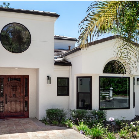 Mediterranean home exterior with arched windows highlighting custom Rancho Santa Margarita CA replacement windows. 