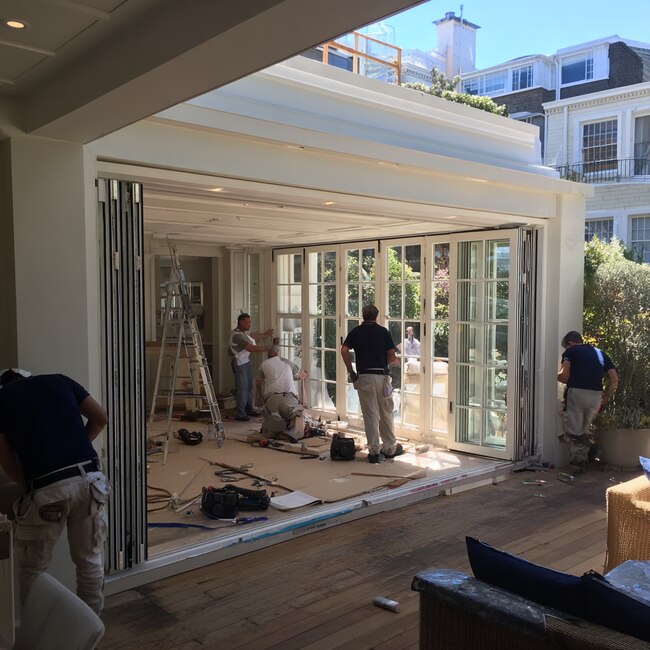 Professional installation of folding glass doors in Laguna Niguel, CA showcasing custom bi-fold door systems