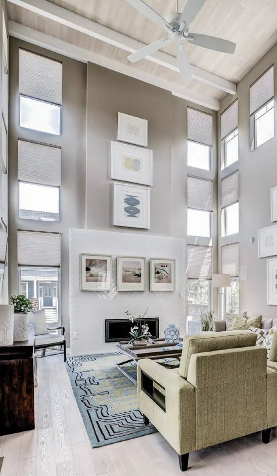 Spacious living room with tall replacement windows that bring in natural light and improve energy efficiency