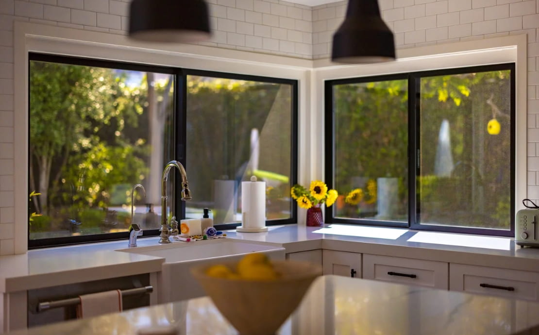 Modern kitchen interior with black framed windows featuring Irvine, CA replacement windows