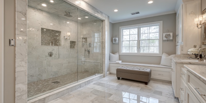 spacious bathroom with marble accents and newport beach, ca replacement windows providing bright natural light